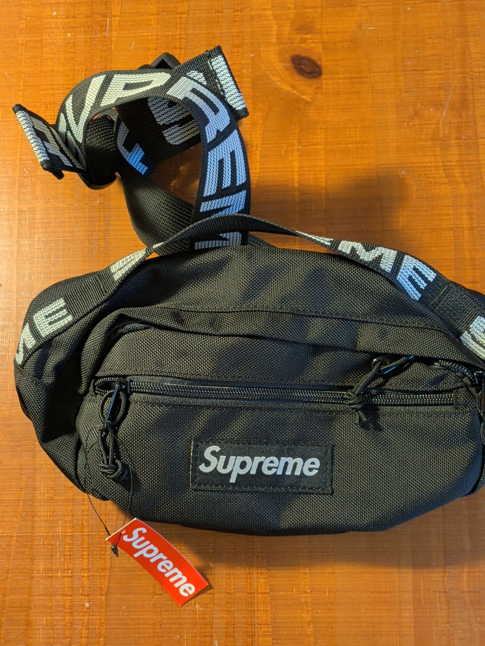 Supreme Black Waist Bag with White Logo Strap and Red Tag